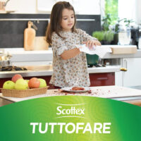 Bambina pulisce cucina con carta Scottex